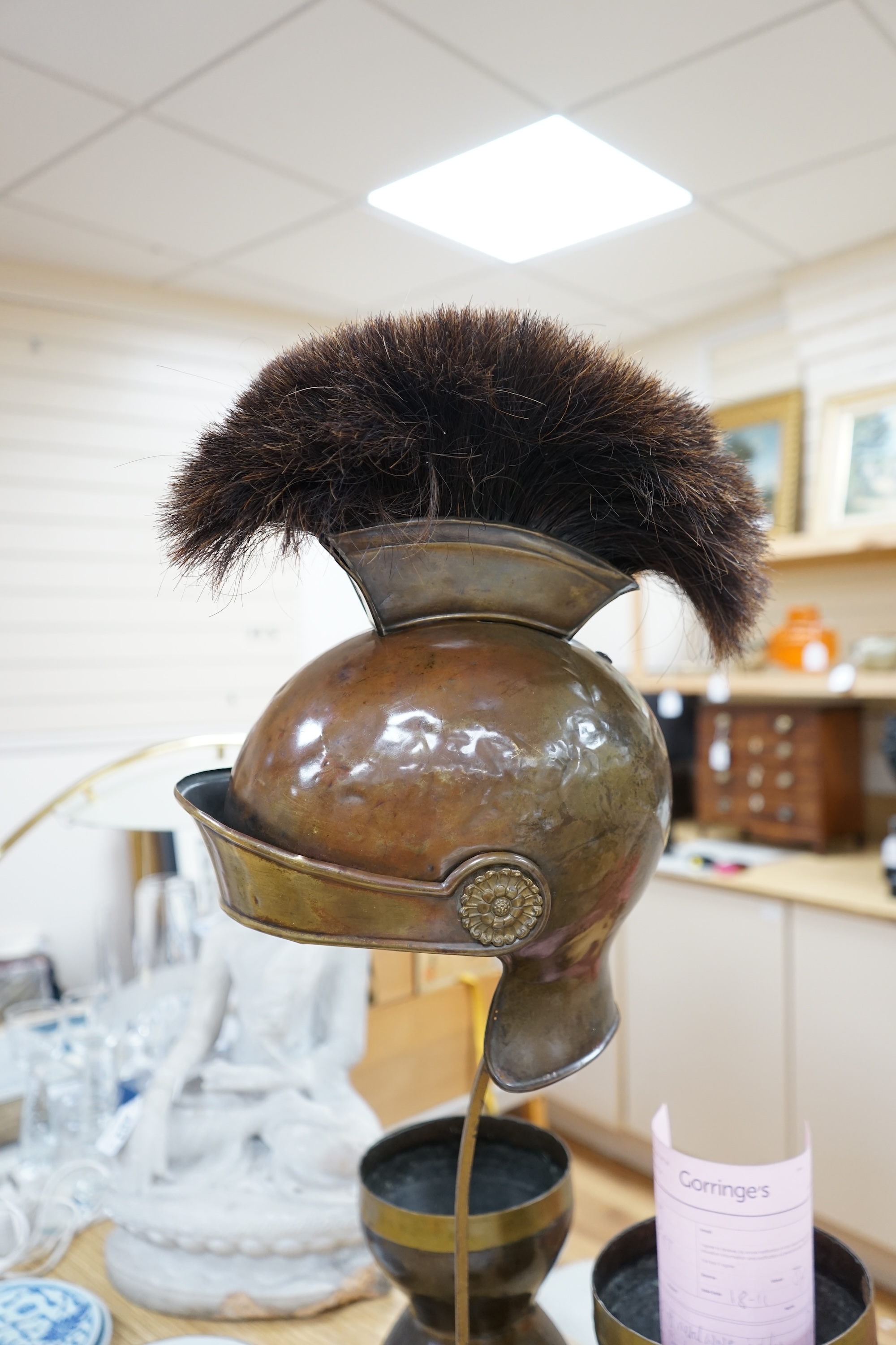 A group of metalware including a Roman style theatrical helmet on stand, a pair of vases and an oil lamp filler, largest 75cm high. Condition - fair to good, lamp filler in antique condition